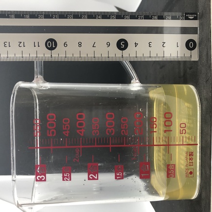 横から見た計量カップに入れた100mlの玄米茶