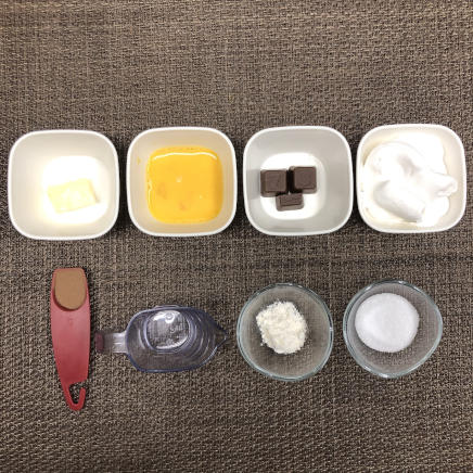 18cm型8等分のチョコケーキに使った材料(1個分に使用した小麦粉・ココア・グラニュー糖・チョコレート・無塩バター・ホイップクリーム・卵・水)