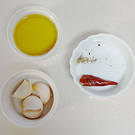 9.5×4cmココット1個分のにんにくのアヒージョに使用した材料（オリーブオイル、にんにく、塩、黒こしょう、唐辛子）